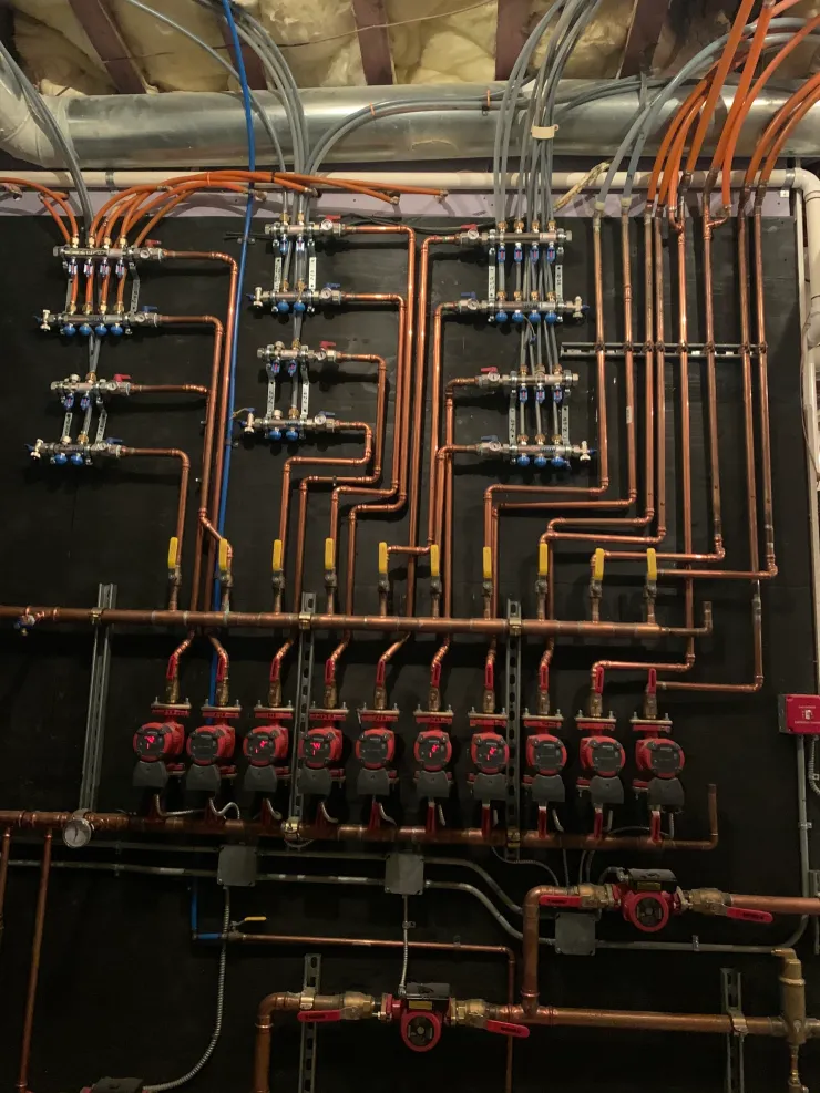 Large copper pipe radiant heating manifold wall